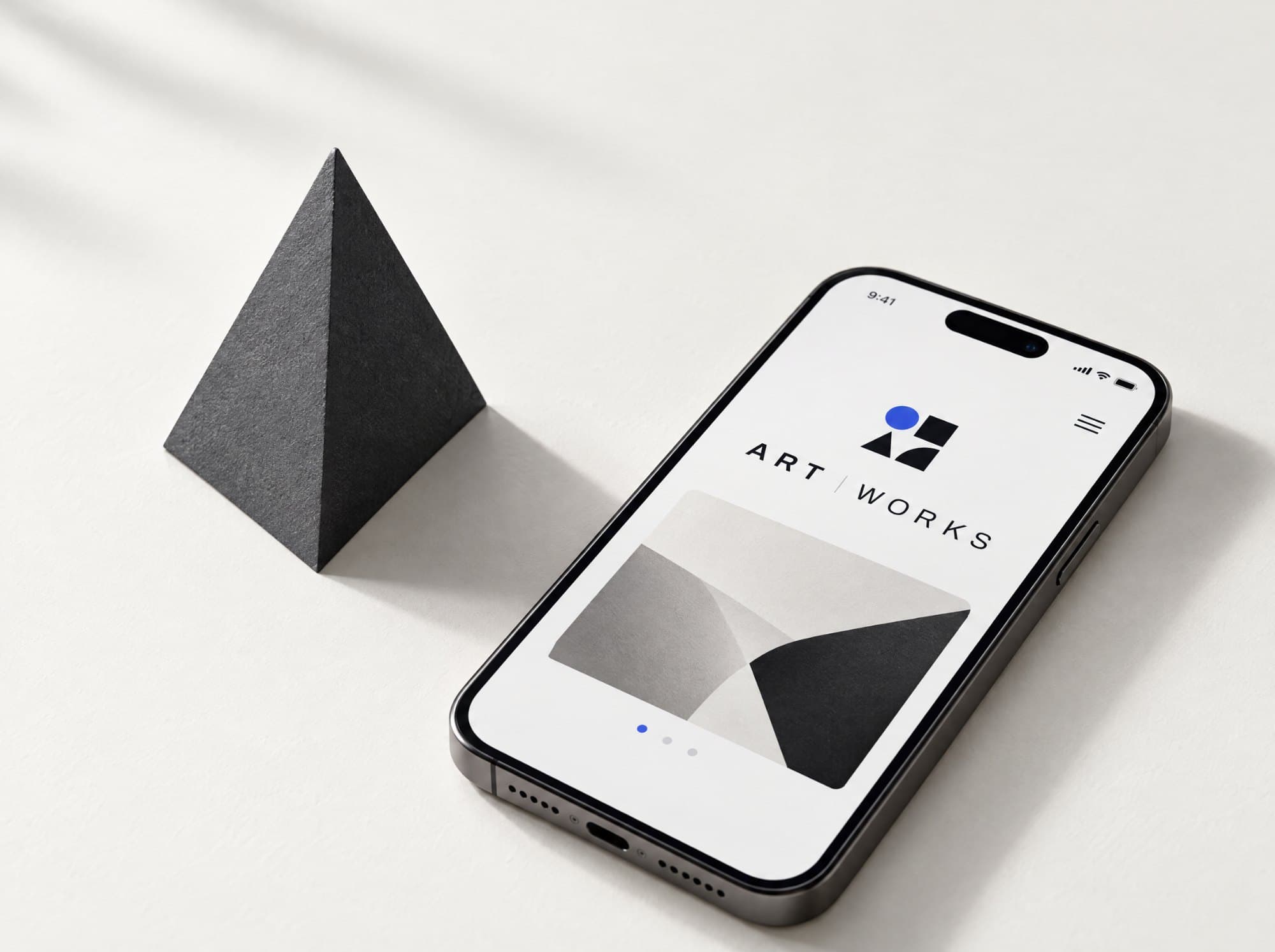 Phone running the ArtWorks app next to a black pyramid